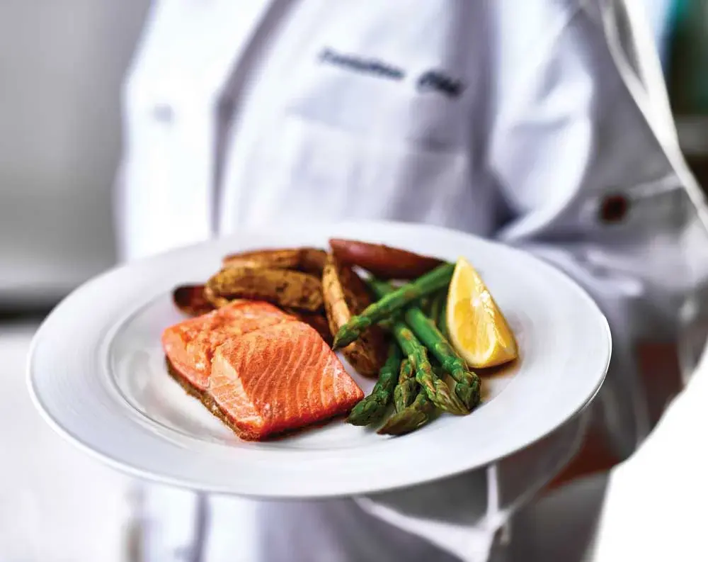 Williams Place Chef Created Meals, chef delivering a finished dish.